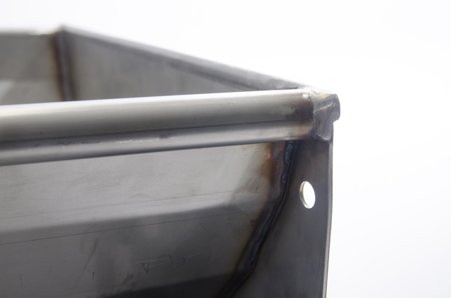 Stainless steel pig trough with a raised edge Beaded edging on a stainless steel trough for fattening pigs